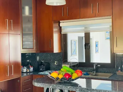 a kitchen with a bowl of fruit on a counter at House of Hera in Livadhia