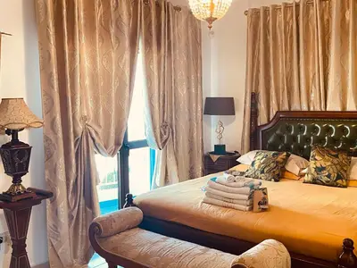 a bedroom with a bed with a chair and a window at House of Hera in Livadhia