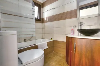 a bathroom with a toilet and a sink and a tub at Seafront Protaras Villas in Protaras