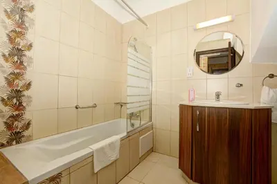 a bathroom with a tub and a sink and a mirror at Seafront Protaras Villas in Protaras