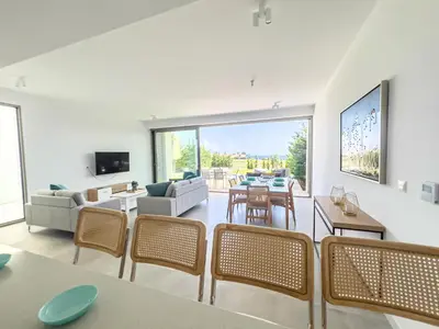a living room with a couch and a table and chairs at Azure Vista Collection in Protaras