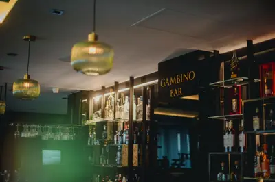a bar with a shelf of drinks and lights at The Ciao Stelio Deluxe Boutique Hotel - Adults Only in Larnaka