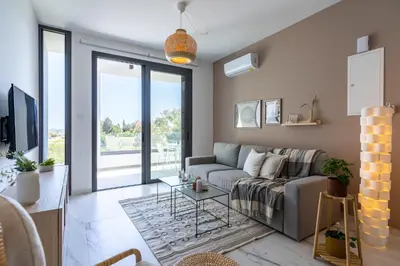 a living room with a couch and a table at Ivory 1-BR Apartment in Aradipou in Aradhippou
