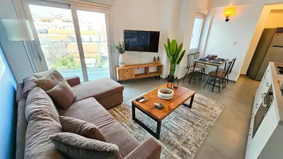 a living room with a couch and a table at Sealife Citycenter Residences in Larnaka