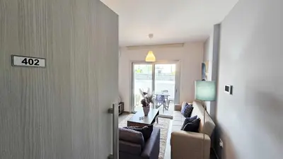 a living room with a couch and a table at Sealife Citycenter Residences in Larnaka