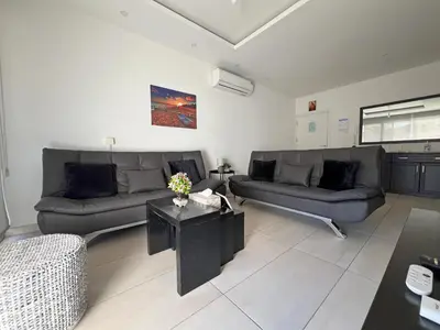 a living room with two couches and a table at Albert's Apartment Center 202B in Larnaka