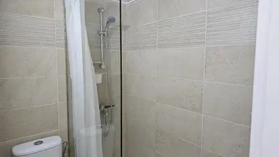 a bathroom with a glass shower with a toilet at STAY Dreamy Seaside Apartment in Larnaka