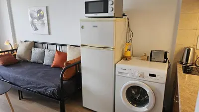 a kitchen with a refrigerator and a washing machine at STAY Dreamy Seaside Apartment in Larnaka