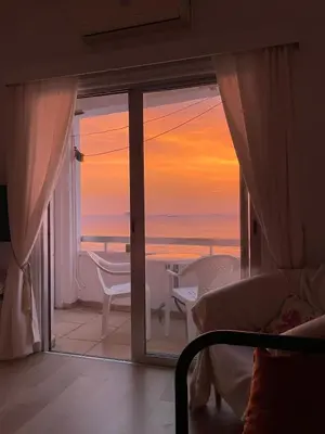 a room with a balcony with a view of the ocean at STAY Dreamy Seaside Apartment in Larnaka
