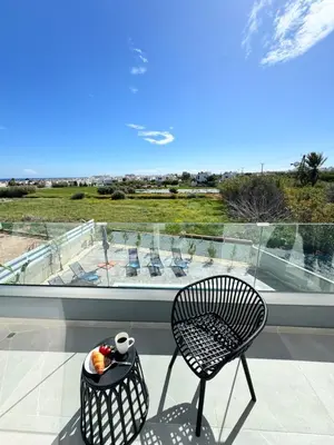 a black chair sitting on a balcony with a view at Protaras Rustic Paradise Luxury Villa 1 in Paralimni
