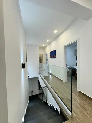 a staircase in a house with white walls at Protaras Rustic Paradise Luxury Villa 1 in Paralimni