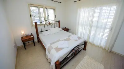 a bedroom with a bed and a window at Pernera Holiday Villa 015 in Protaras