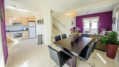 a kitchen and dining room with a table and chairs at Pernera Holiday Villa 012 in Protaras