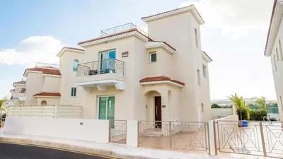 a large white house with a fence in front of it at Pernera Holiday Villa 012 in Protaras