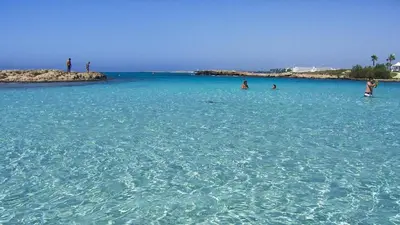 a group of people swimming in the ocean at Ayia Napa Holiday Villa 003 in Ayia Napa
