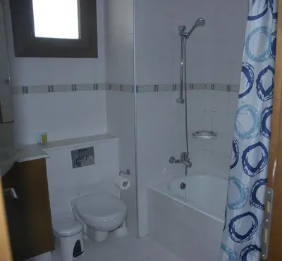 a bathroom with a shower and a toilet and a sink at Summer Breeze in Paralimni