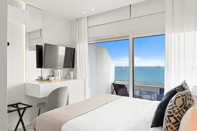 a bedroom with a bed and a view of the ocean at Phaedrus Living: Limassol Seaside Residences 01 in Limassol