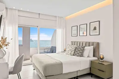 a bedroom with a bed and a view of the ocean at Phaedrus Living: Limassol Seaside Residences 02 in Limassol