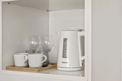 a shelf with a coffee maker and wine glasses at Phaedrus Living: Limassol Seaside Residences 02 in Limassol