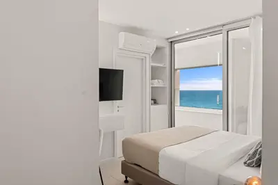 a bedroom with a bed and a window with the ocean at Phaedrus Living: Limassol Seaside Residences 03 in Limassol