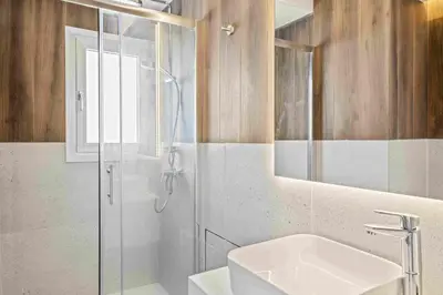a bathroom with a shower and a sink and a mirror at Phaedrus Living Coastal Seaside Residences 04 in Limassol