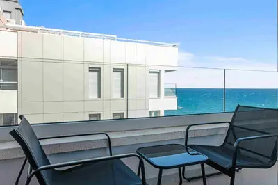 two chairs and a table on a balcony with the ocean at Phaedrus Living Coastal Seaside Residences 04 in Limassol