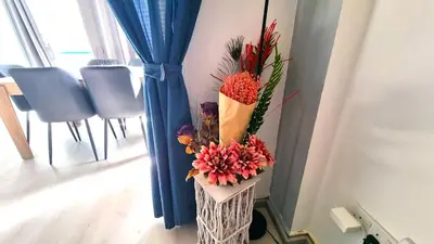 a vase filled with flowers in a room at 2Br Apt Coastal Comfort with Internet Access in Larnaka