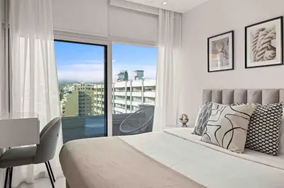 a bedroom with a bed and a large window at Phaedrus Living Limassol Seaside Residences 06 in Limassol