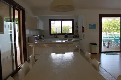 a kitchen and dining room with a table and chairs at The Olive Tree in Protaras