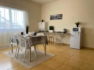 a kitchen and dining room with a table and chairs at STUDIO in Limassol