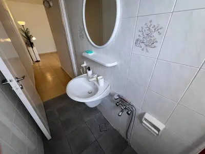 a bathroom with a white sink and a mirror at STUDIO in Limassol