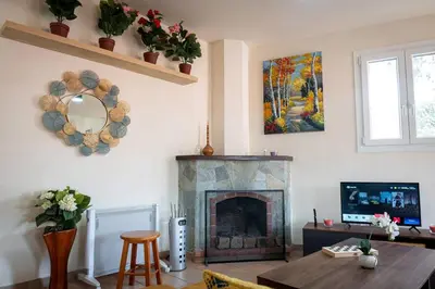 a living room with a fireplace and a tv at Hubstay Hillside Residence with Private Jacuzzi in Platres