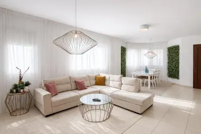 a living room with a couch and a table at Villa Dolce Vita in Protaras