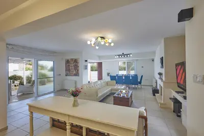 a living room with a couch and a table at Protaras Serifos Villa Sv07 in Paralimni