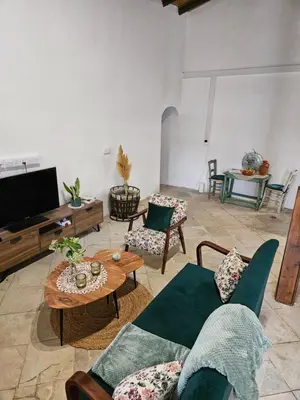 a living room with a couch and a table at Traditional adobe house in Evrychou with cozy garden and fireplace! in Nicosia