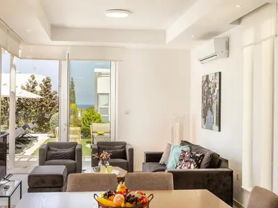a living room with couches and a table at Villa Natalie-Mylos H24 in Protaras