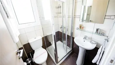 a bathroom with a shower and a toilet and a sink at Protaras Holiday Villa 045 in Protaras