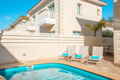 a villa with a swimming pool and a house at Protaras Holiday Villa 035 in Protaras