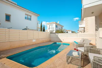 a swimming pool in the backyard of a house at Protaras Holiday Villa 035 in Protaras