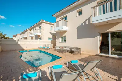 a patio with chairs and a swimming pool at Protaras Holiday Villa 035 in Protaras