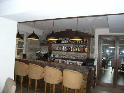 a bar with a row of chairs and lights at Livadia Hotel Kyperounta in Kyperounda