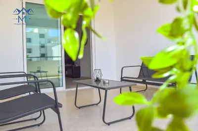 three chairs and a table in a room with a table at SeaWitch Apartment in Larnaka