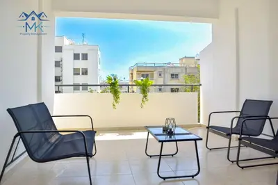 a room with three chairs and a table on a balcony at SeaWitch Apartment in Larnaka