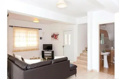 a living room with a couch and a table at Villa Cypriana in Protaras