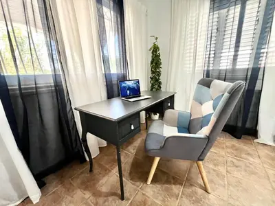 a desk with a laptop and a chair in a room at STAY Princess Villa in Protaras