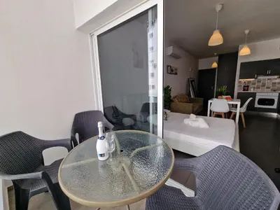 a glass table and chairs in a living room at Tropical Paradise 200m from Finikoudes beach in Larnaka