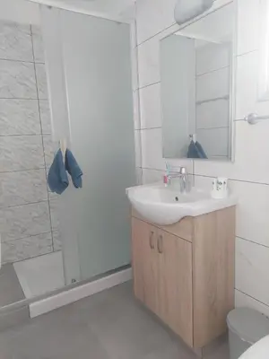 a bathroom with a sink and a shower at Green Bay Suites in Protaras
