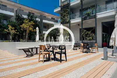 a patio with tables and chairs in a building at NEW 2BR Townhouse in Luxury Resort Pool & Beach in Protaras