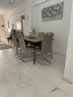 a dining room with a table and chairs at Quattro City Center Apartments in Larnaka