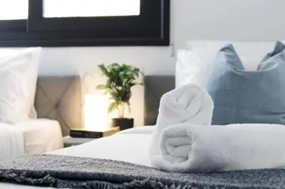 a pile of towels sitting on top of a bed at Luxury Stay at Mackenzie Beach with Private Parking and Balcony in Larnaka